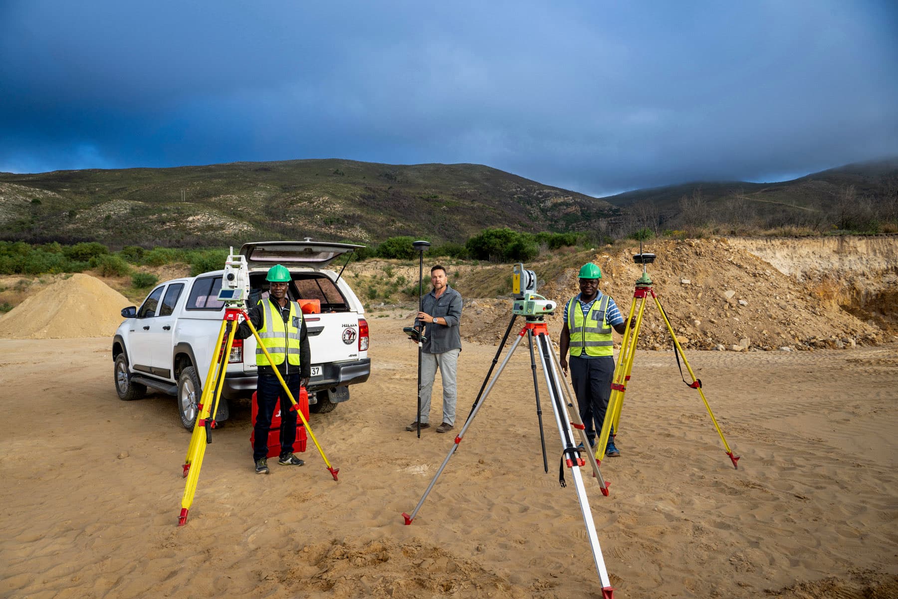 The GeoSurv team on site with a robotic total station, GNSS rovers and the company bakkie.